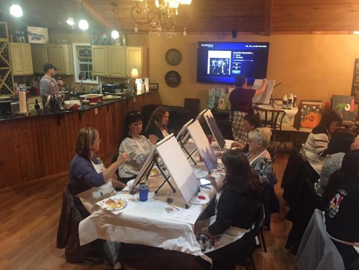 Everyone just sat down ready to learn about painting and to make something beautiful as a keepsake. Behind the bar, we have bottles of red or white wine just waiting to be served.
